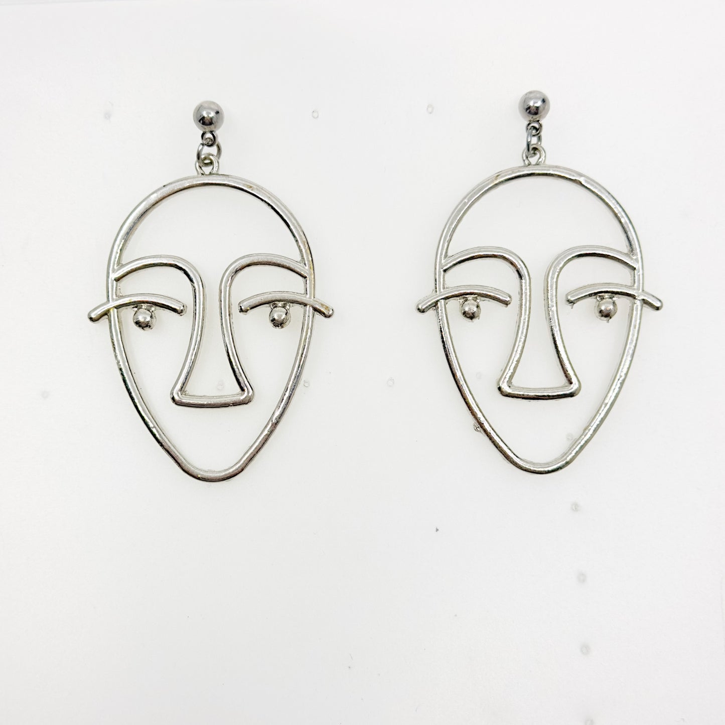 Silver tone face earrings