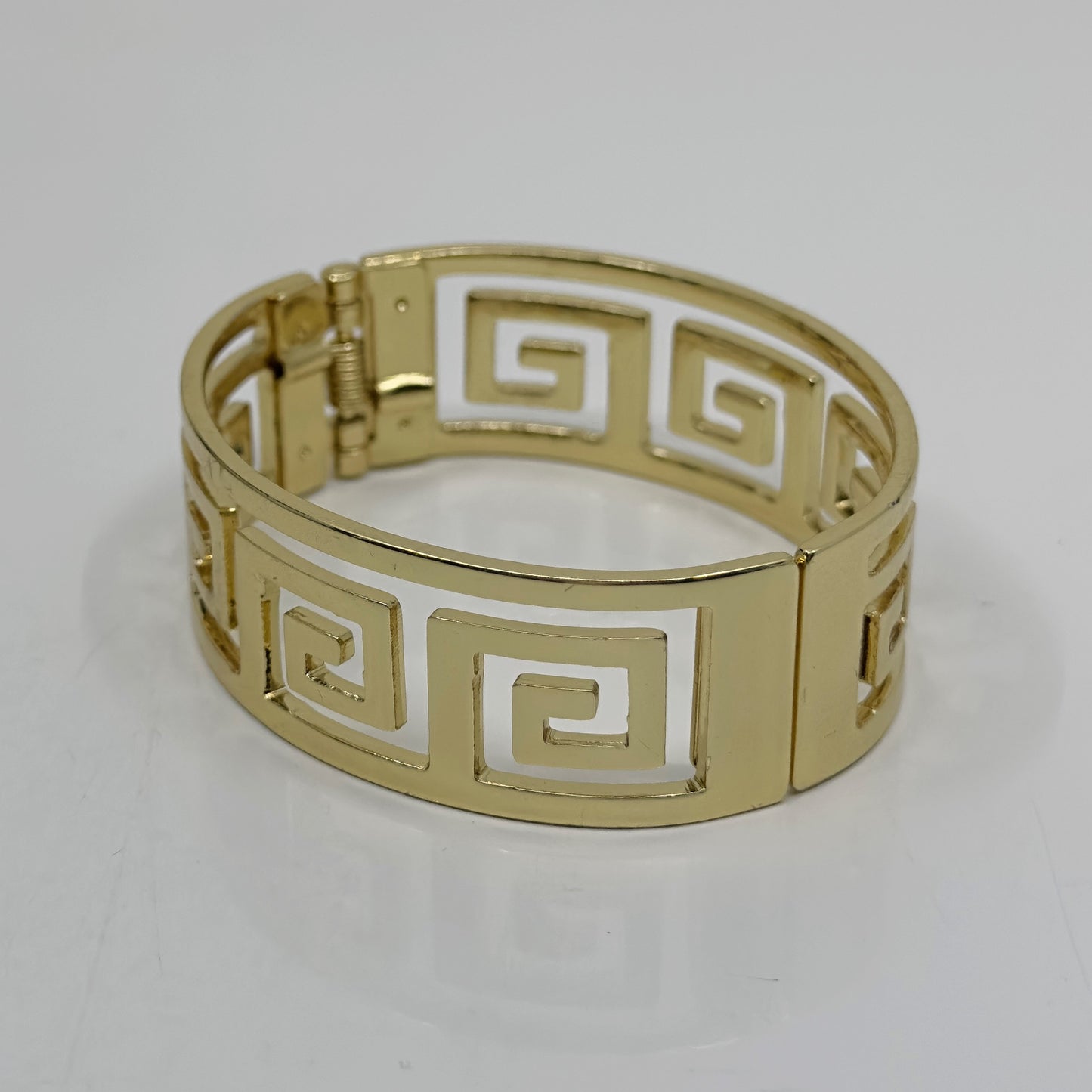 Gold Tone Greek key hinged bangle bracelet