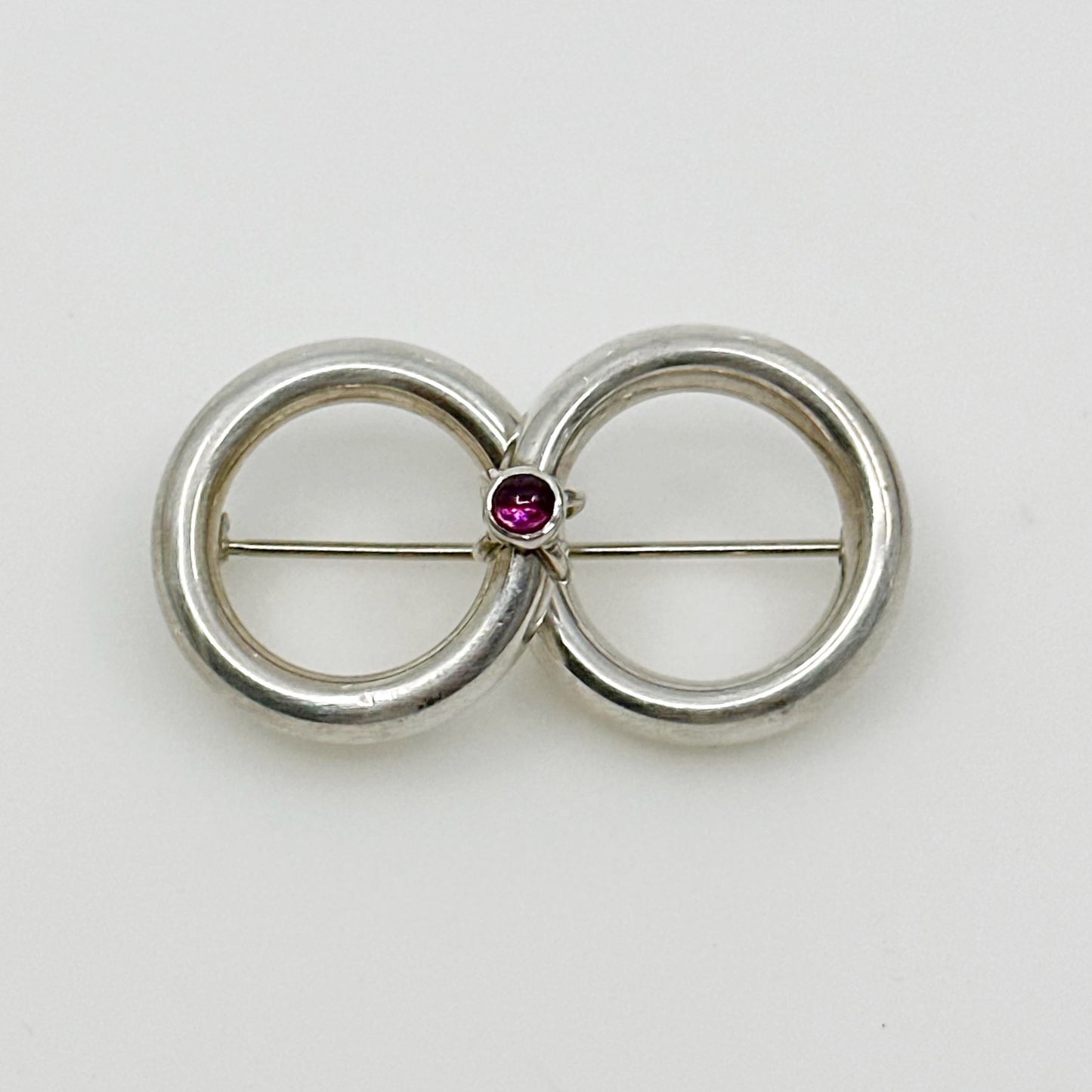 Sterling silver garnet cabochon infinity brooch