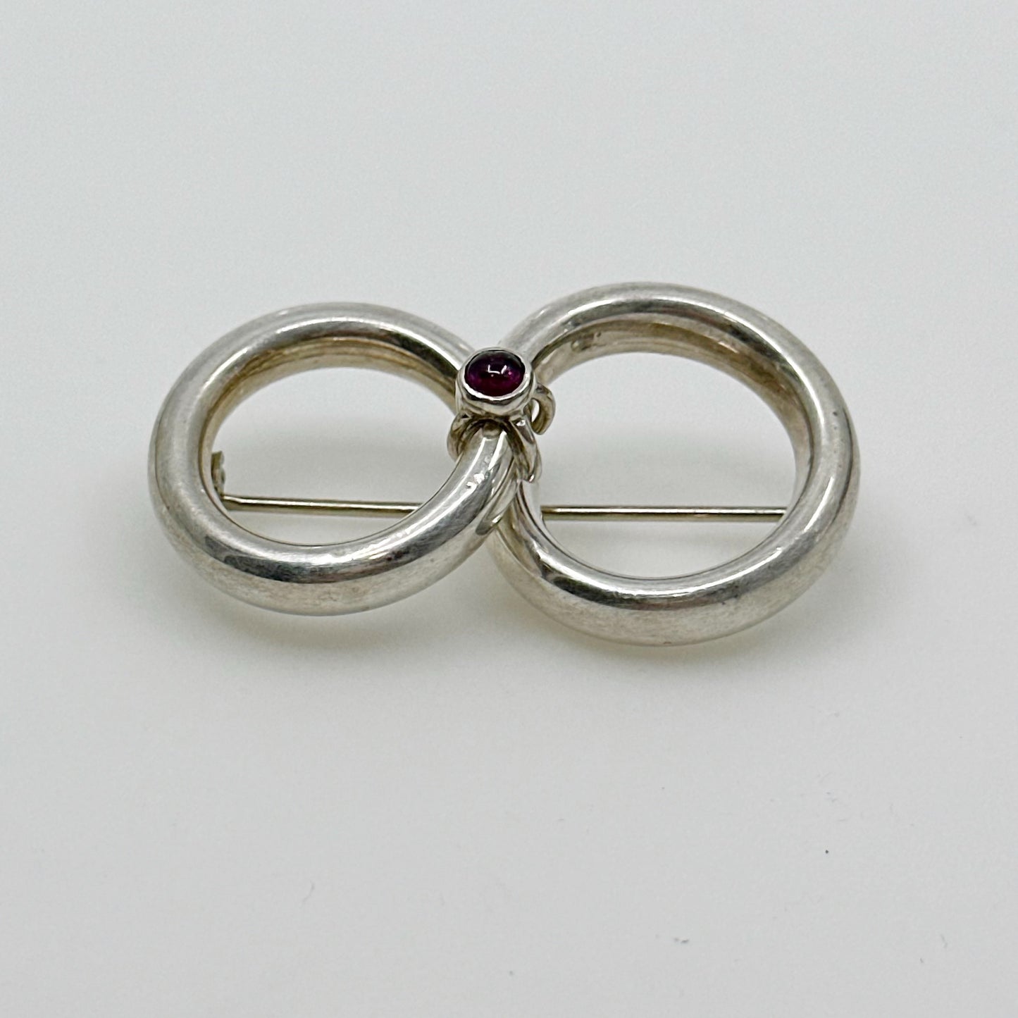 Sterling silver garnet cabochon infinity brooch