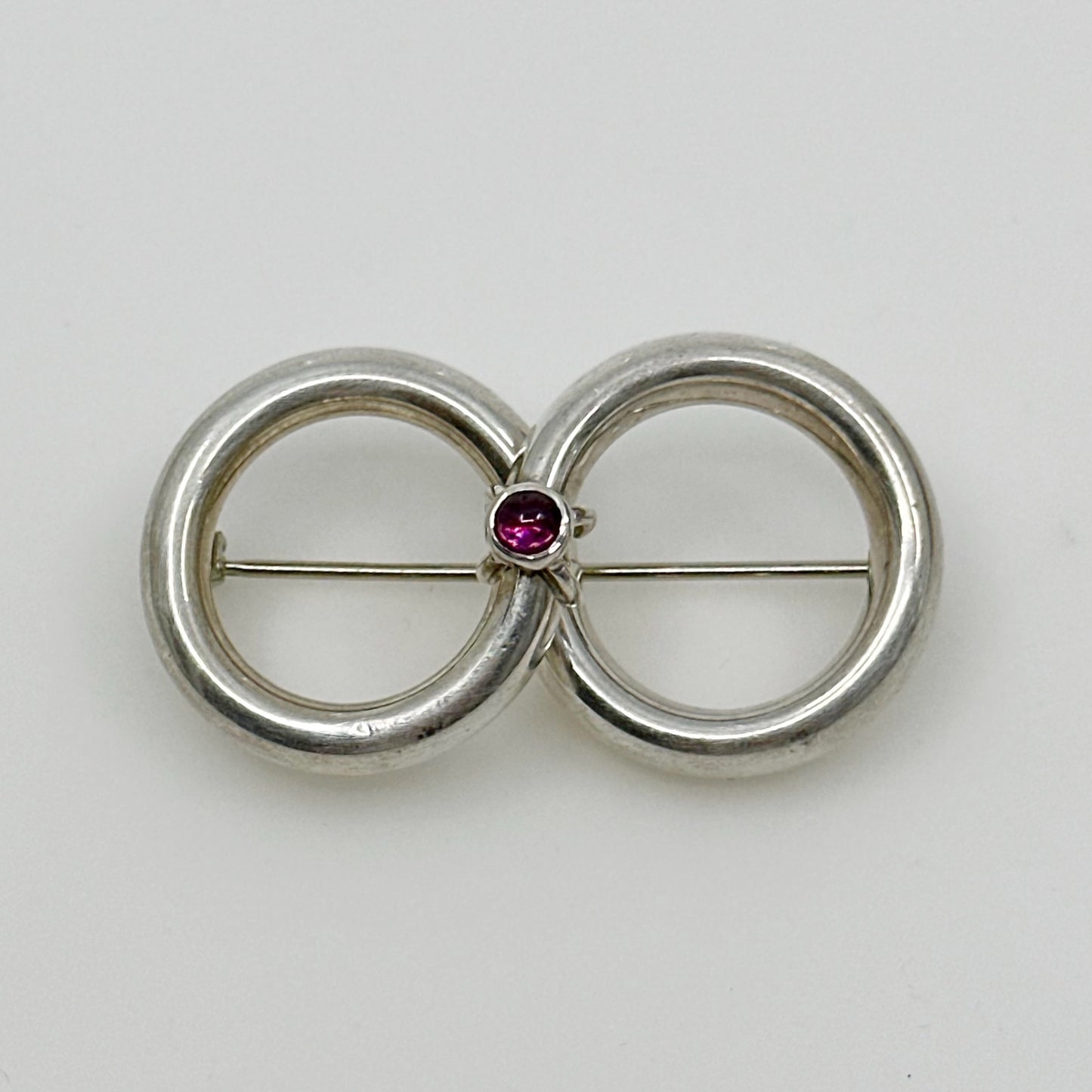 Sterling silver garnet cabochon infinity brooch