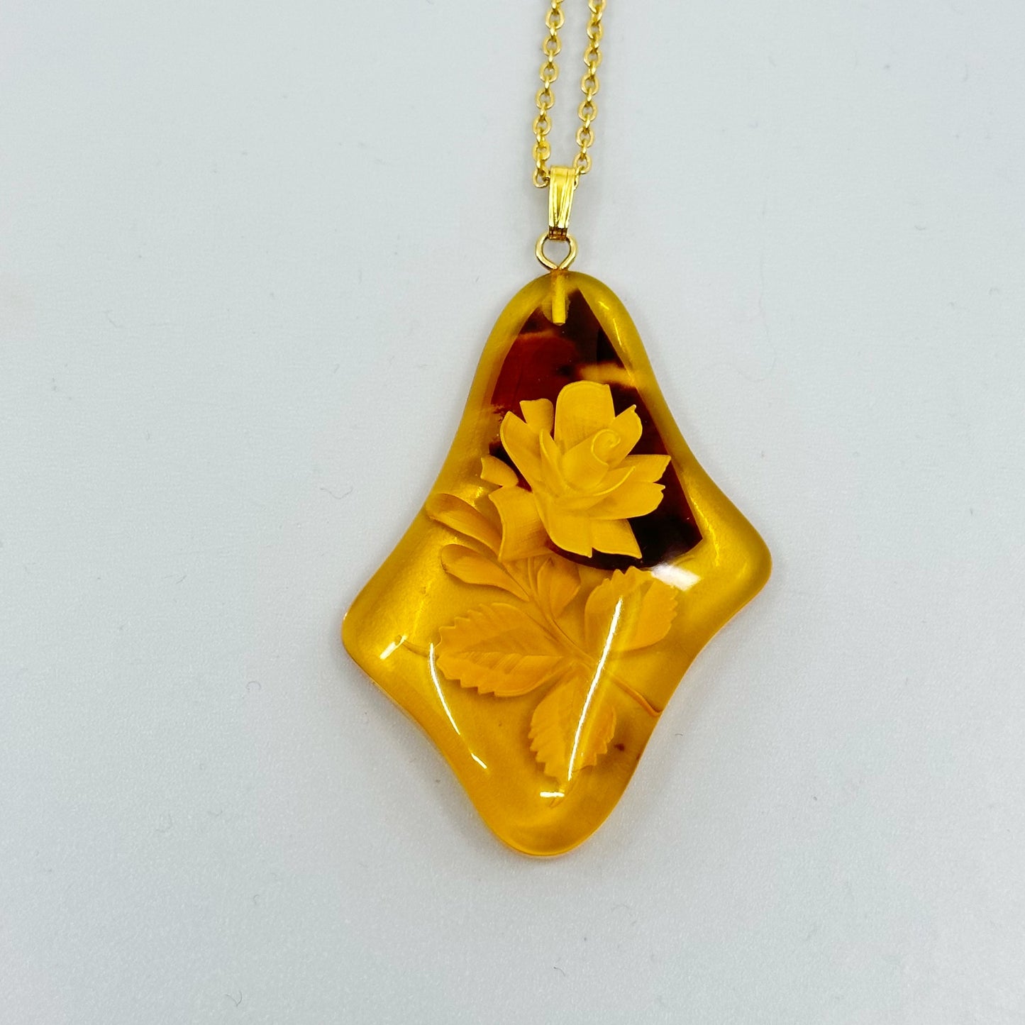 gold plated reverse carved rose baltic amber pendant necklace